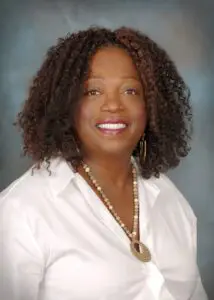 A woman with long hair and a white shirt.